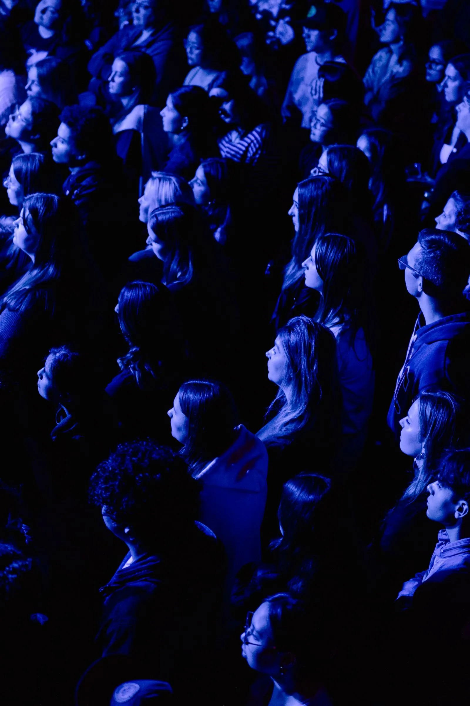 Faces in the crowd lit blue