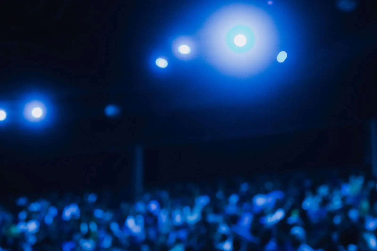Spotlights over a dark audience